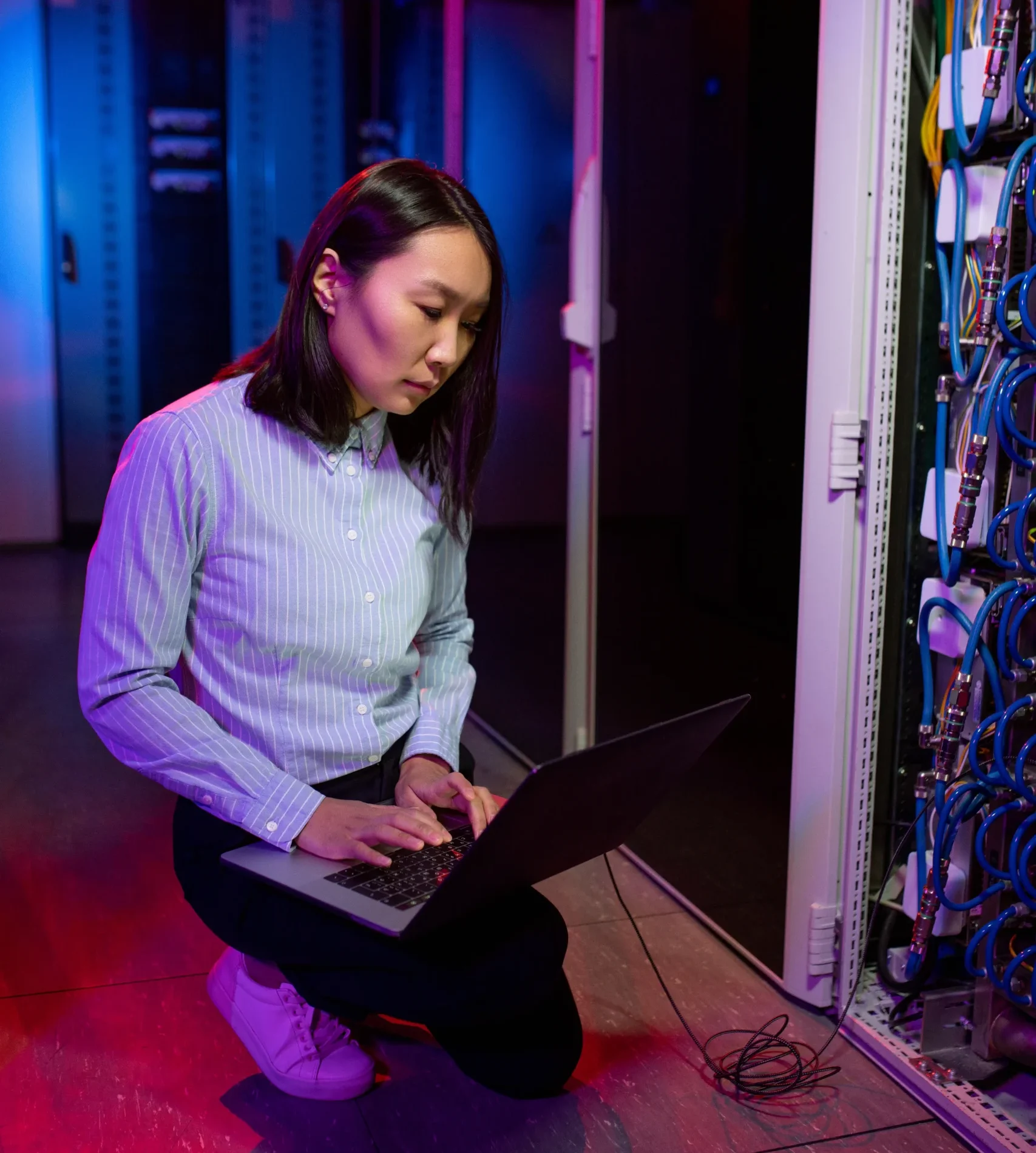 concentrated-asian-technician-using-laptop